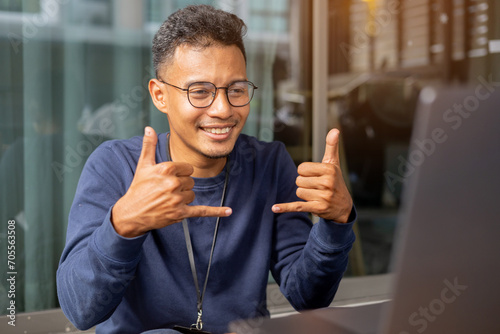 close up asian indian man make gesture hand about playing sign language to teaching or talking to colleague in office meeting room for business lifestyle concept photo