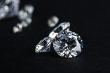 Many beautiful shiny diamonds on black background, closeup