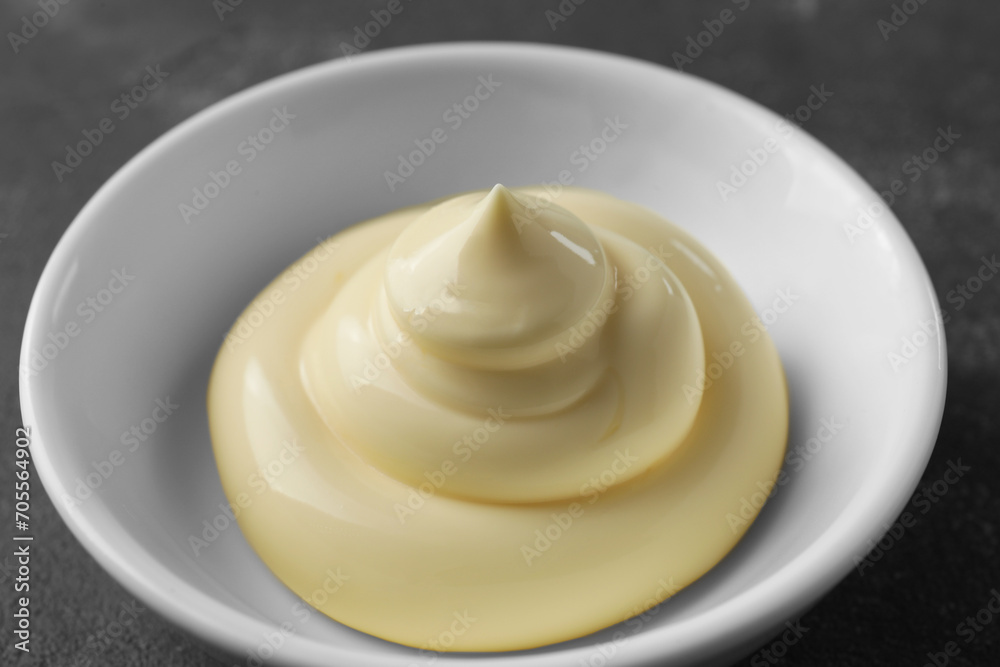 Fresh mayonnaise sauce in bowl on grey table, closeup Fresh mayonnaise sauce in bowl on grey table, closeup