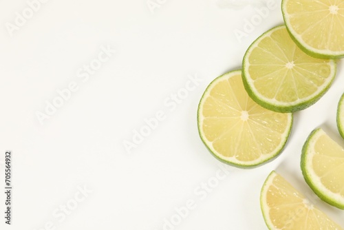 Lime pieces on white background, above view. Space for text