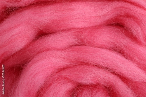 Pink felting wool as background, closeup view