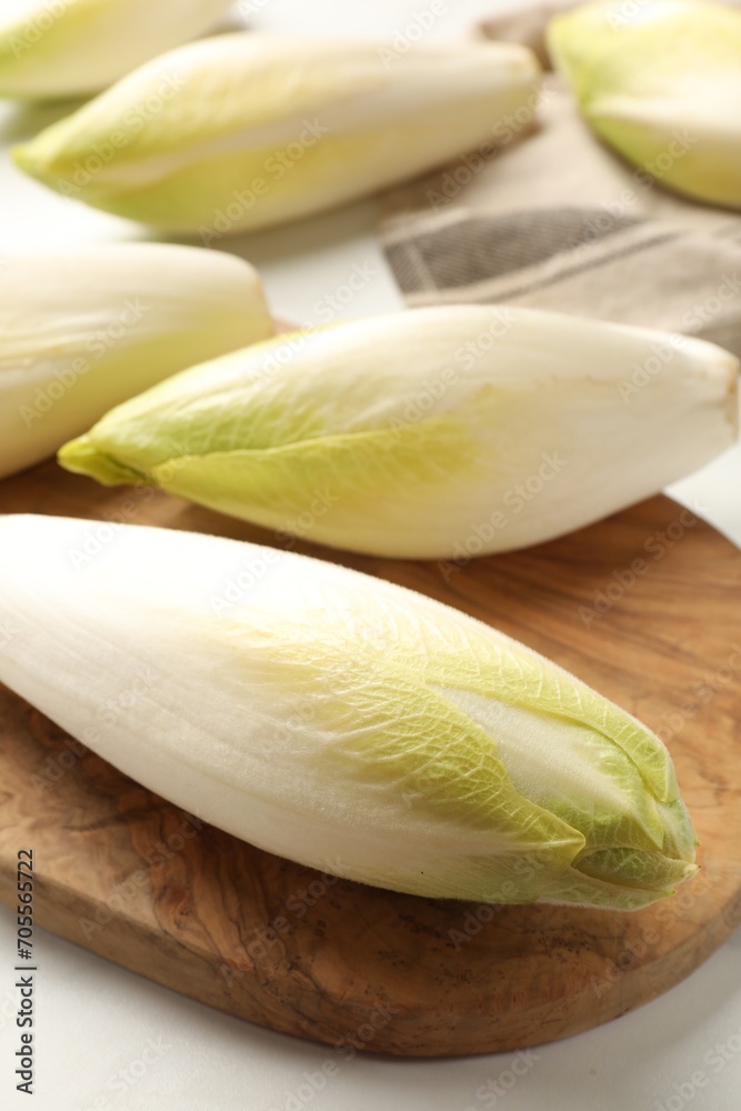 Raw ripe chicories on white marble table, closeup Raw ripe chicories on white marble table, closeup