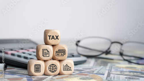 Obraz na płótnie Tax concept with icons on wooden blocks Tax reduction planning, expenses, accounting, VAT and property taxes