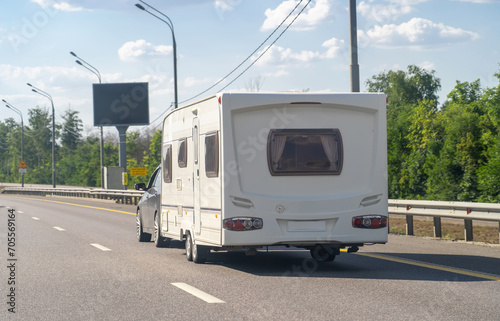 Car with motor home trailer on freeway road