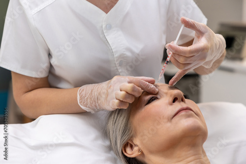 Mature woman receiving anti age teatment at beauty clinic