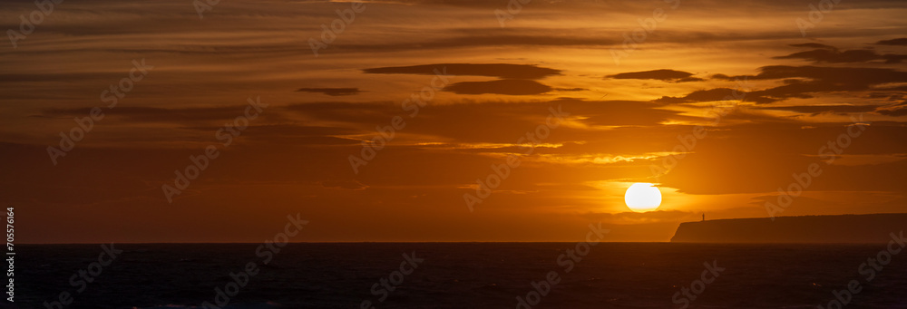 Fototapeta premium Majestic Lighthouse at World s End During Vibrant Sunset