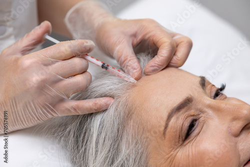 Woman having beauty procedures at beauty clinic and receiving beauty injections