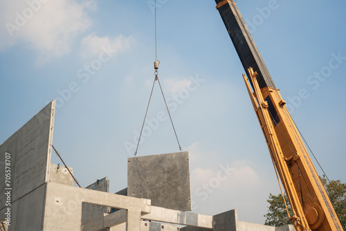 Obraz na płótnie mobile crane lifting precast concrete wall panel to installation new building at Construction site