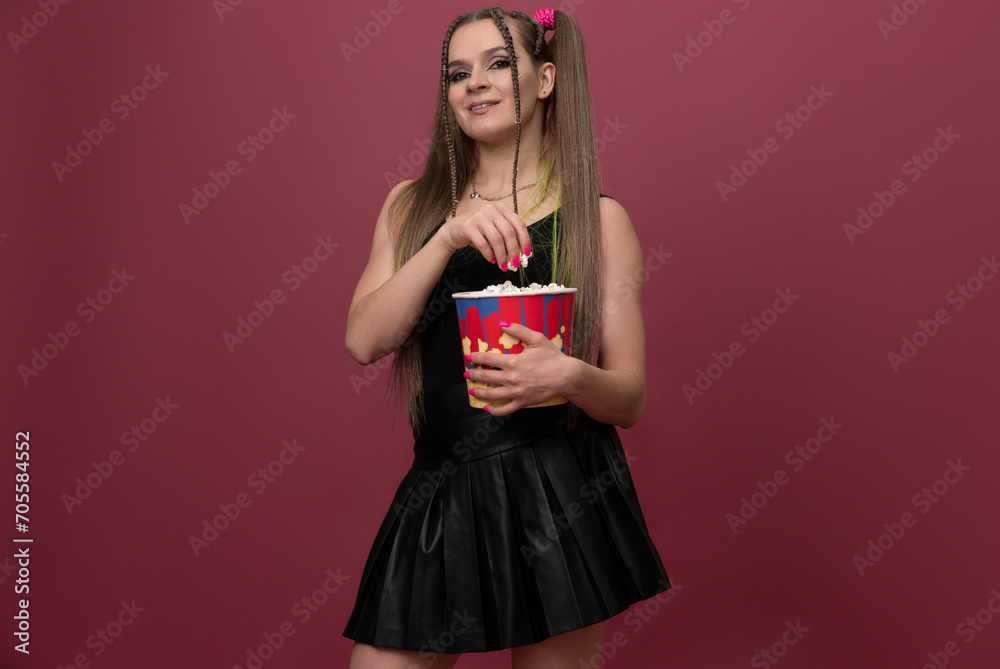 Portrait of impressed lady hand hold popcorn isolated on red color background Portrait of impressed lady hand hold popcorn isolated on red color background