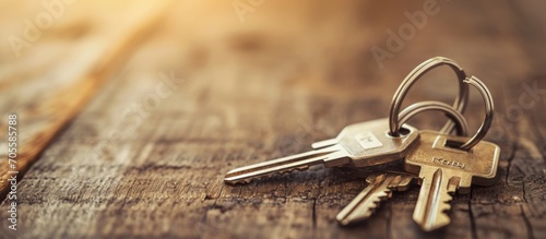 Keys with house key ring on wooden table. photo