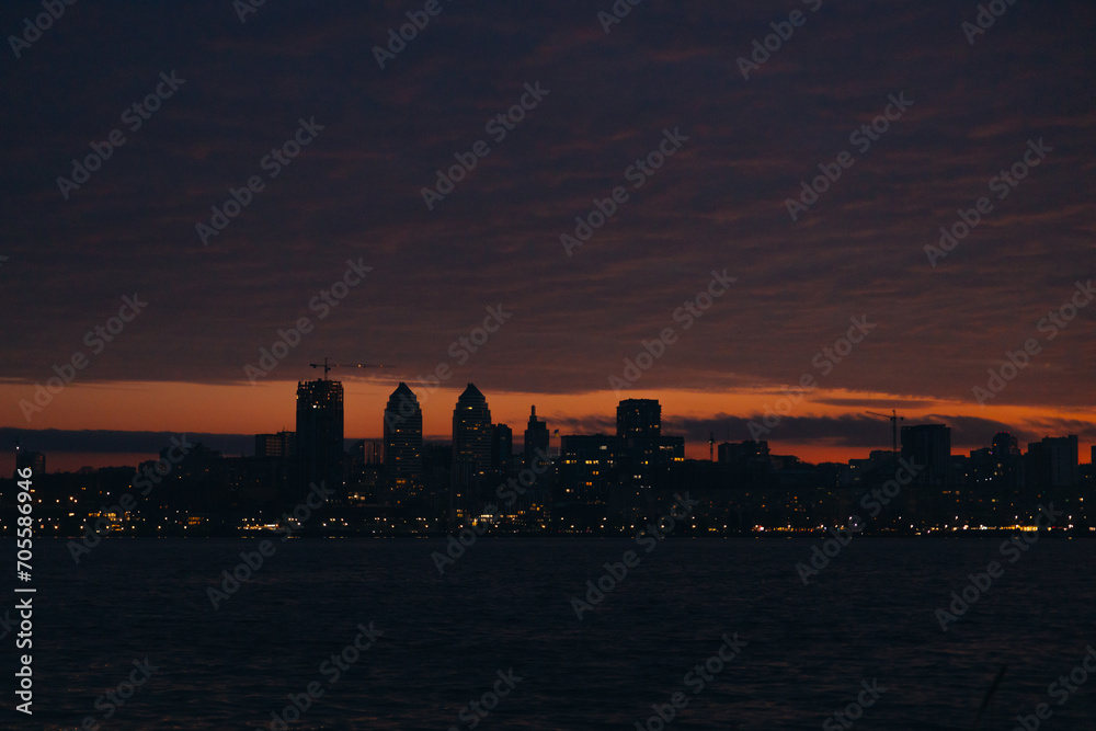 Panoramic view of the city of Dnipro during sunset or sunrise. Amazing sunset at Dnipro river with a view of the historical center. Winter sunset. Evening city. Panoramic view of the city of Dnipro during sunset or sunrise. Amazing sunset at Dnipro river with a view of the historical center. Winter sunset. Evening city.