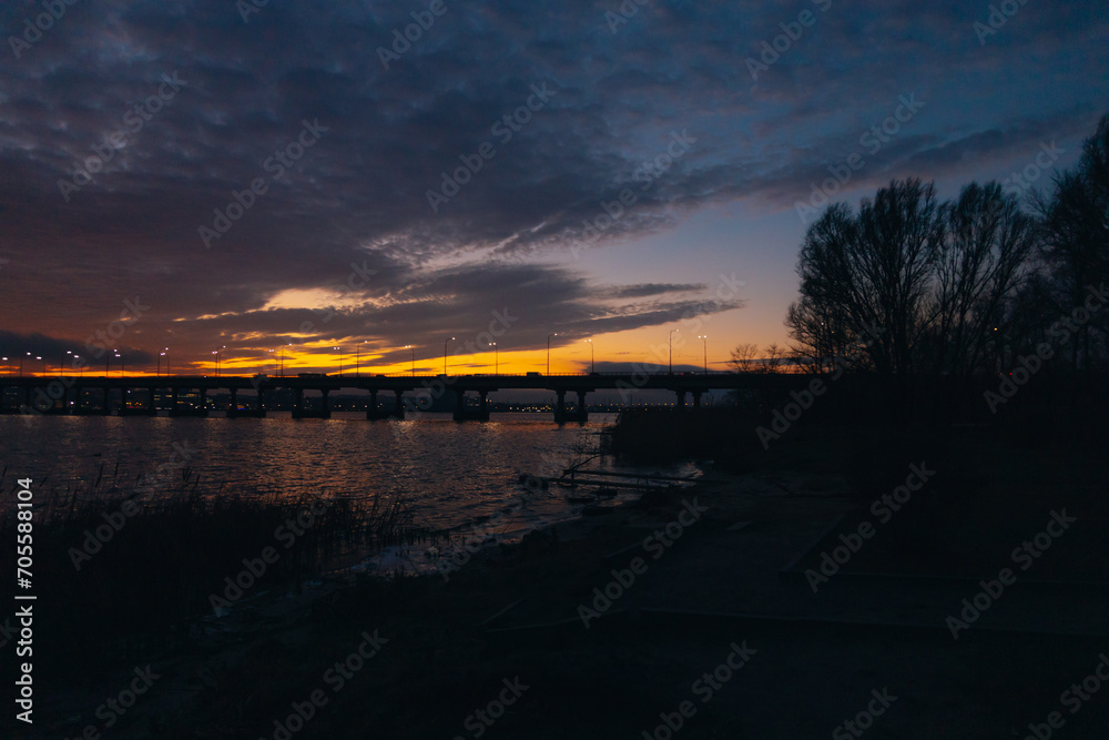 Panoramic view of the city of Dnipro during sunset or sunrise. Amazing sunset at Dnipro river with a view of the historical center. Winter sunset. Evening city.