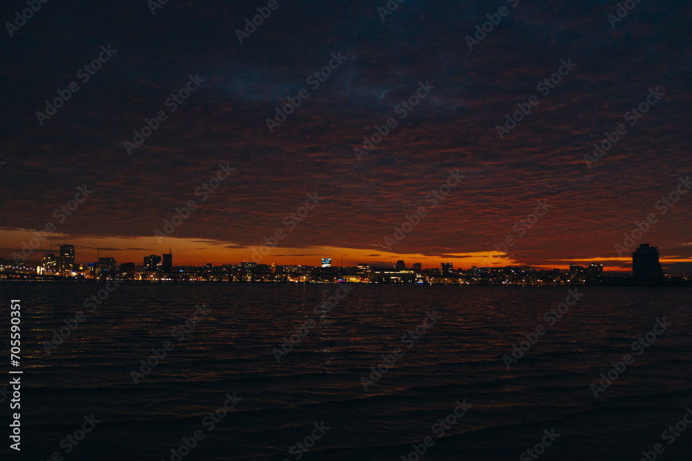 Panoramic view of the city of Dnipro during sunset or sunrise. Amazing sunset at Dnipro river with a view of the historical center. Winter sunset. Evening city.