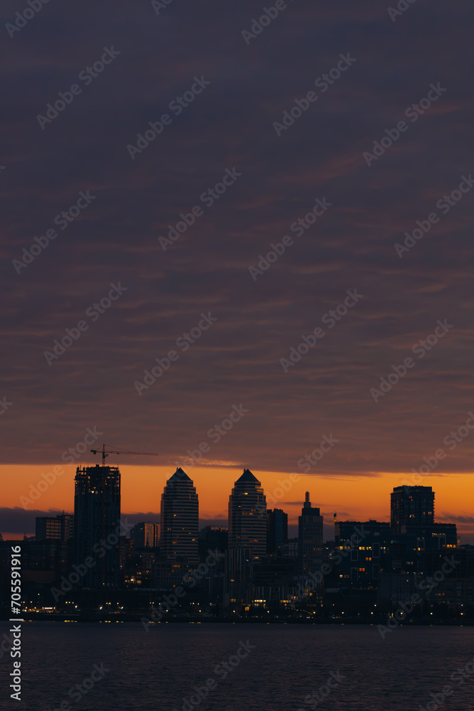 Panoramic view of the city of Dnipro during sunset or sunrise. Amazing sunset at Dnipro river with a view of the historical center. Winter sunset. Evening city.