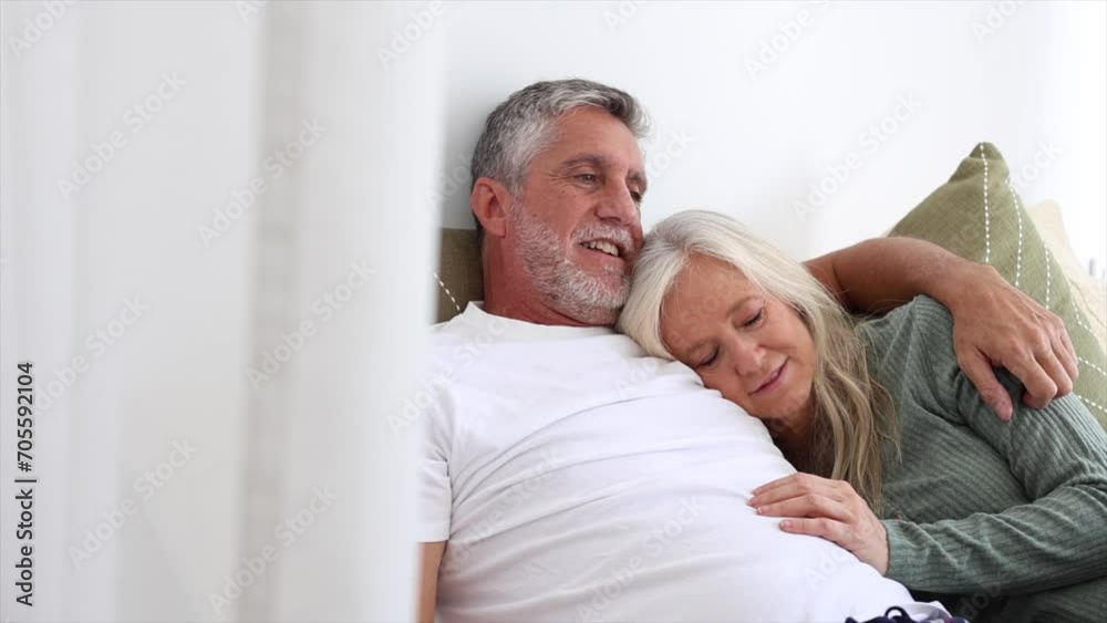 woman leaning on her husband's chest lying in bed woman leaning on her husband's chest lying in bed