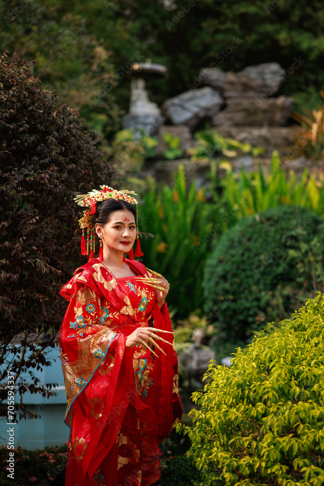 Chinese new year , Portrait of young asian woman with traditional red Chinese hong hao cheongsam in temple ,