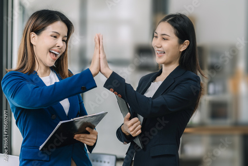 Happy creative business people are motivated, giving high five and celebration successful deal. Cooperation Meeting Partnership Career growth Team building Successful business.