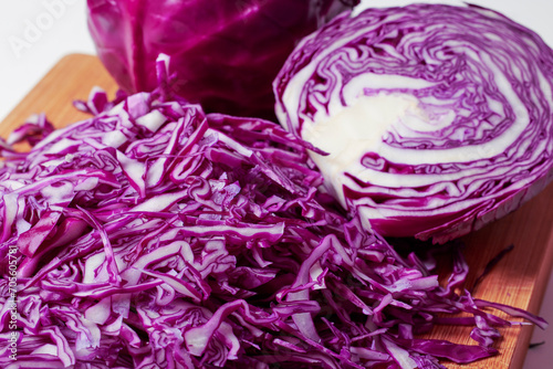 Chopped red cabbage on a wooden chopper.