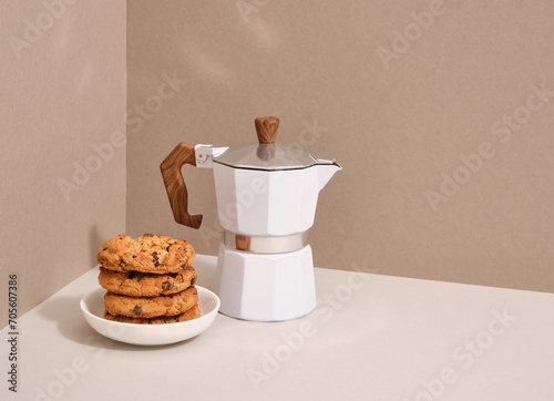 Geyser coffee maker and chocolate chip cookie. Light breakfast. Copy space for text.
