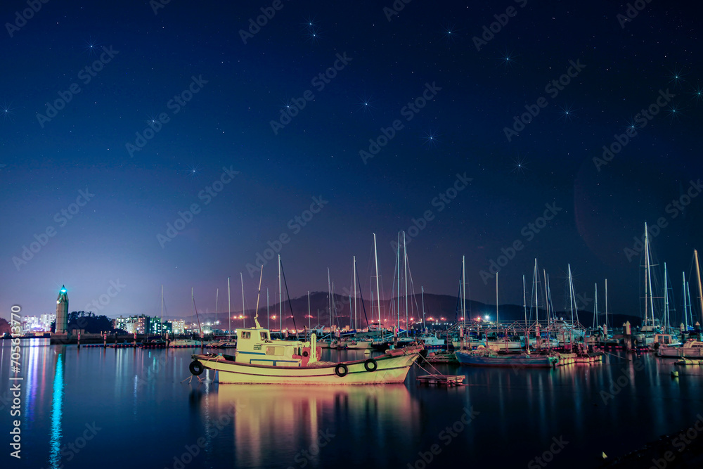 The night view of the port where fishing boats are anchored. The night sea view of Tongyeong Port, South Gyeongsang Province, Korea