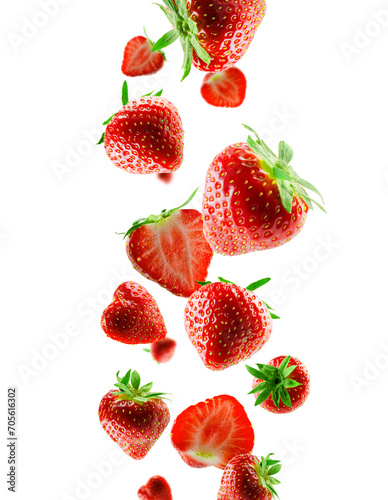 Excellently retouched whole and halved strawberries fall into space. Surround light from behind. Isolated on white