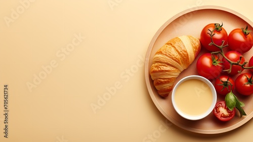 A breakfast platter with a tomato, egg, and croissant on a beige backdrop, Generative AI. © Electric Wolf