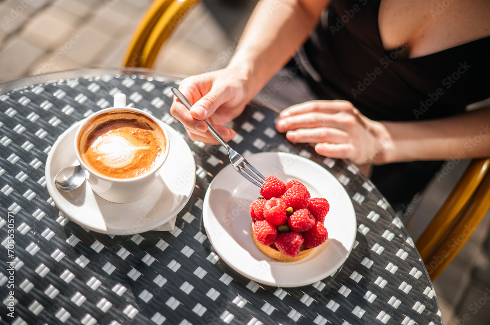 a beautiful dessert with raspberries and a cup of coffee