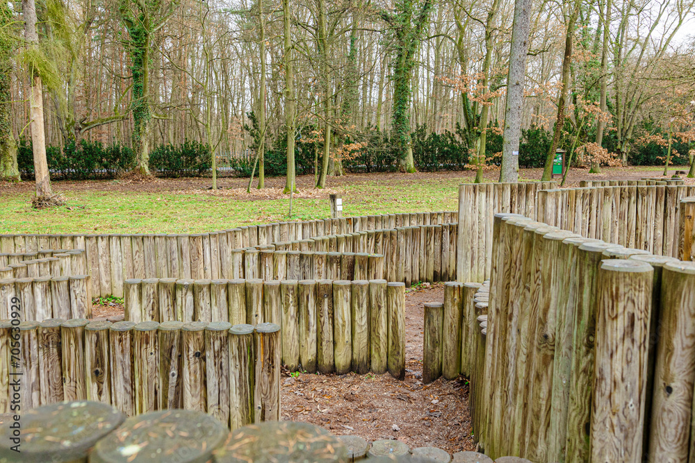 General view of the wooden labyrinth among the trees on the lawn on a spring day General view of the wooden labyrinth among the trees on the lawn on a spring day
