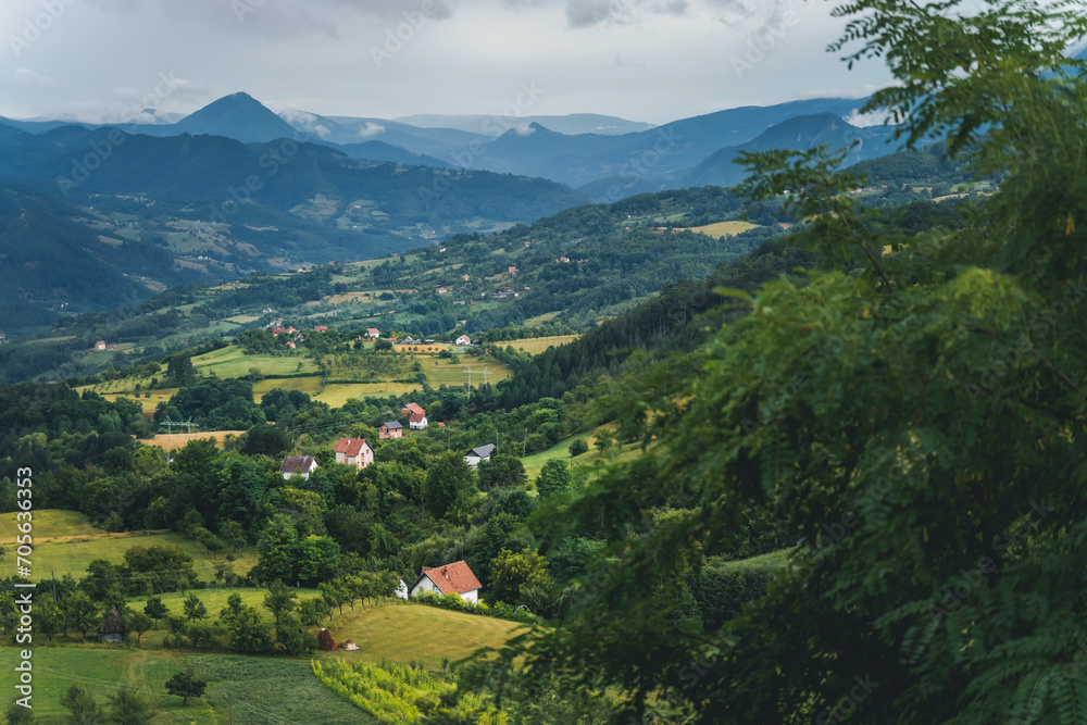 Beautiful rural summer landscape. Traditional Serbian village in the mountains. Arial view Beautiful rural summer landscape. Traditional Serbian village in the mountains. Arial view