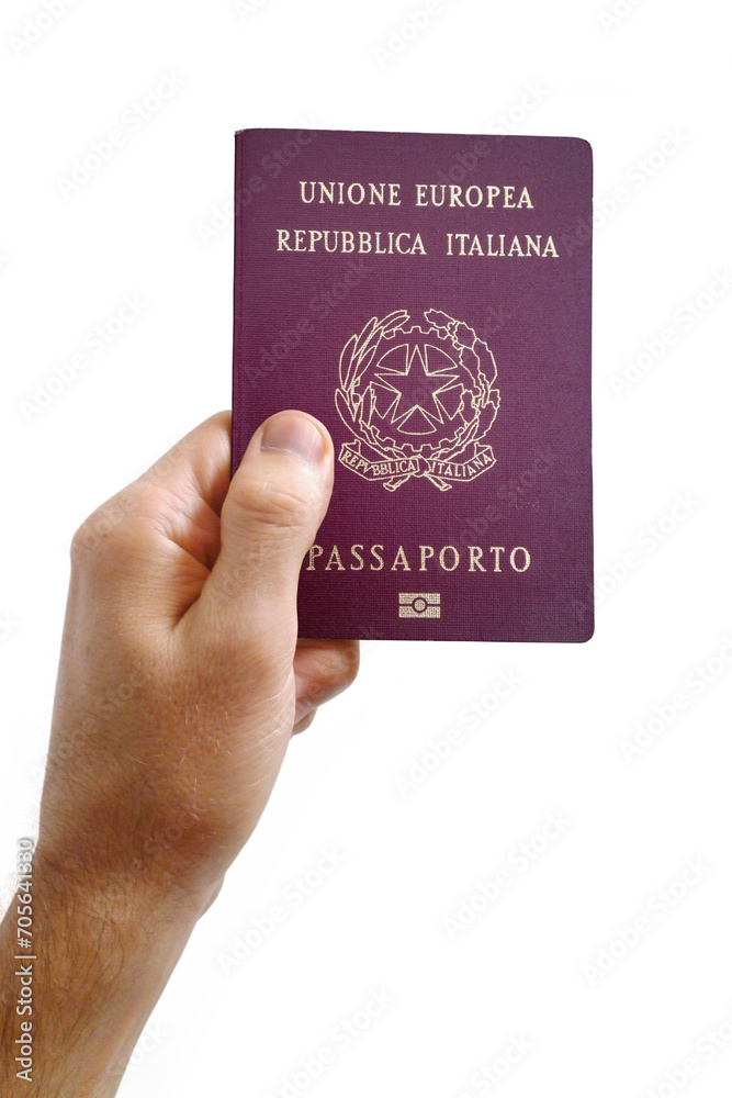 Man's hand holding an Italian passport Man's hand holding an Italian passport