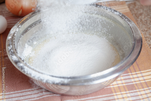 Sifted flour is poured into a bowl....