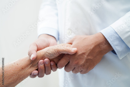 Doctor holding hands Asian elderly woman patient, help and care in hospital.