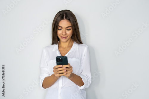 Portrait of a businesswoman using mobile phone isolated over white background