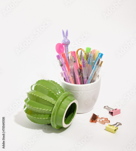 Composition of bright office supplies and part of a green cactus figurine. Concept back to school.