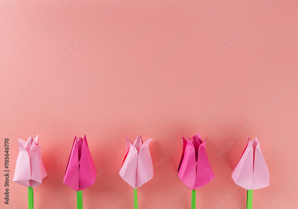Tulips made of colored paper on a pink background, handmade. Mother's day, women's day concept.