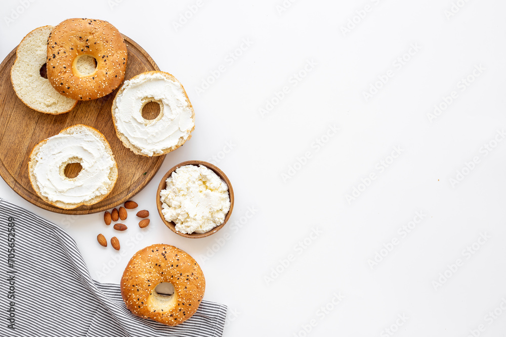 Homemade baked bread bagels with cheese cream. Healthy breakfast background