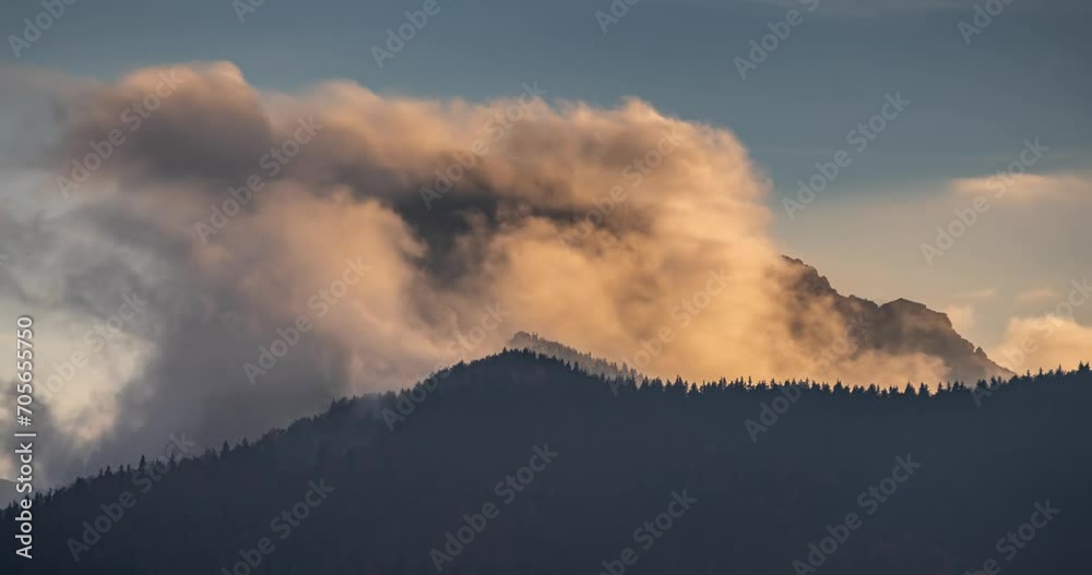 Misty clouds over alps mountains peak, evening light of sunset Time lapse Misty clouds over alps mountains peak, evening light of sunset Time lapse