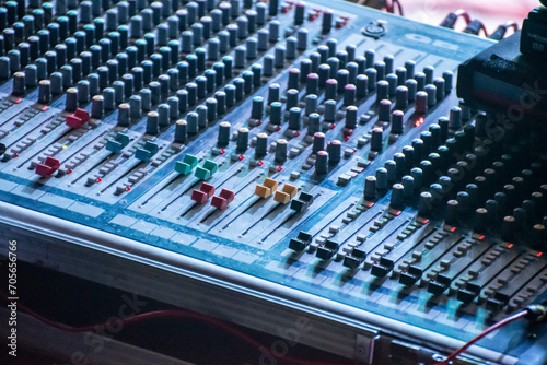 Sound engineer using mixing console to produce a sound track.