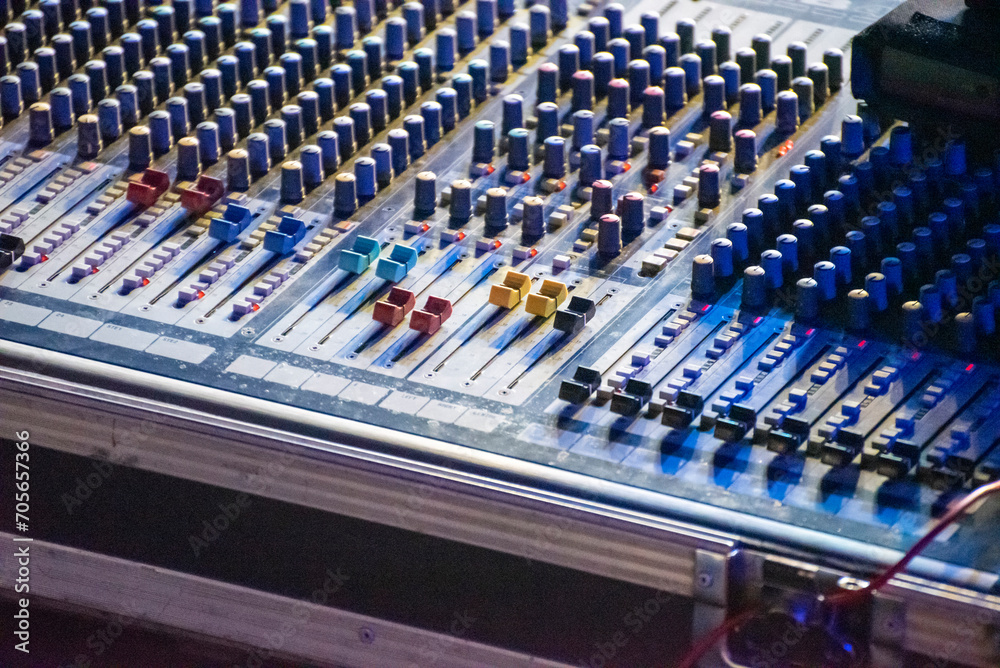 Obraz premium Sound engineer using mixing console to produce a sound track.