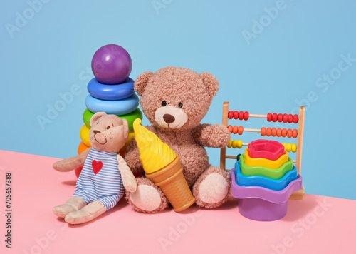 Colorful collection of kids toys and childhood. Soft bears, sand toys, abacus, ice cream and pyramid with colored rings. © Dima