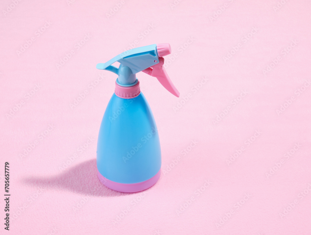 Blue plastic spray bottle with water or cleaner for cleaning. Copy space for text. Blue plastic spray bottle with water or cleaner for cleaning. Copy space for text.