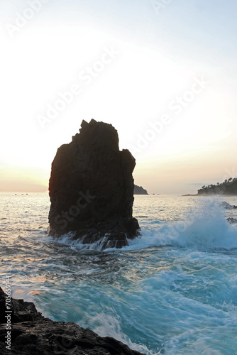 Beautiful rocky beach of East Java, Indonesia in the late afternoon. Low light landscape photography.