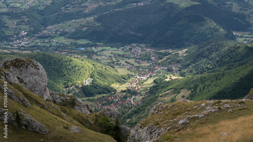 Naklejka premium Sunspot on settlement in valley, view from mountain Vlasic