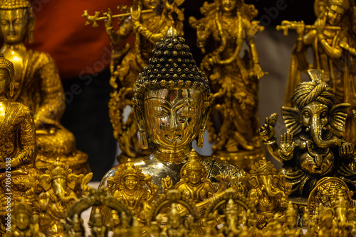 Brass metal art, Handmade Lord Buddha sculpture souvenir made with brass with blur background. Selective focus. © Abhishek Mittal