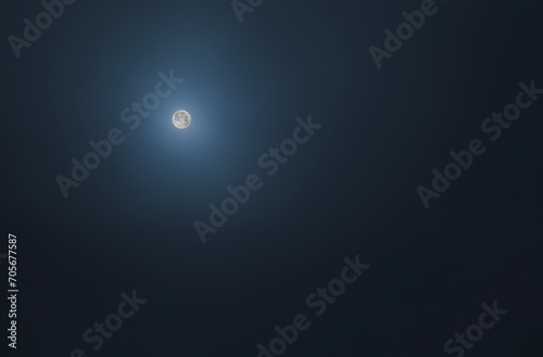 full moon on dark clear blue sky