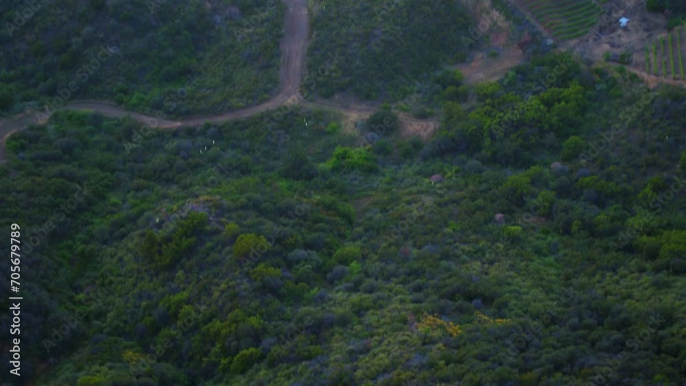 Aerial Tilt Down Beautiful View Of Bungalow On Green Mountain During Tranquil Weather - Malibu, California Aerial Tilt Down Beautiful View Of Bungalow On Green Mountain During Tranquil Weather - Malibu, California