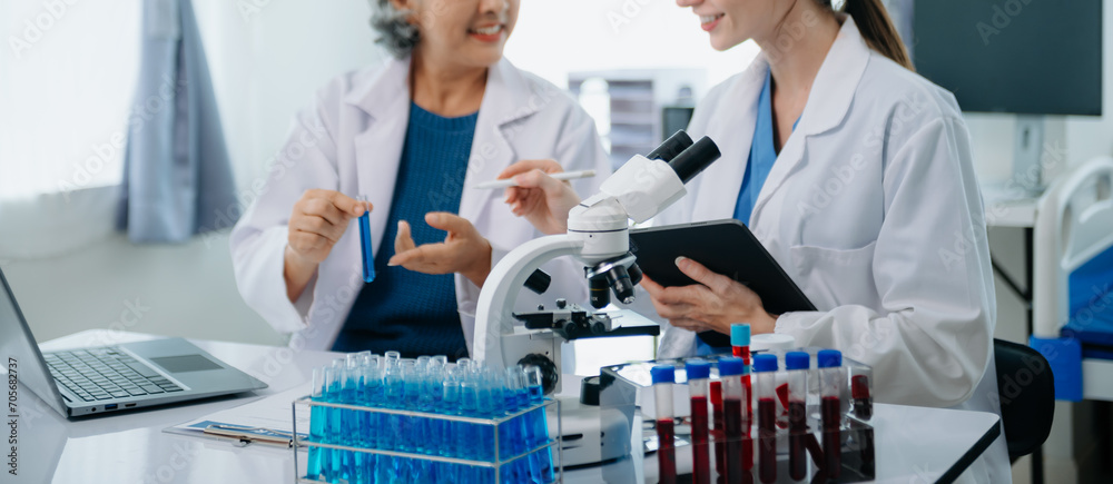 Scientist team meeting and writing analysis results in the laboratory study and analyze scientific sample. Scientist team meeting and writing analysis results in the laboratory study and analyze scientific sample.