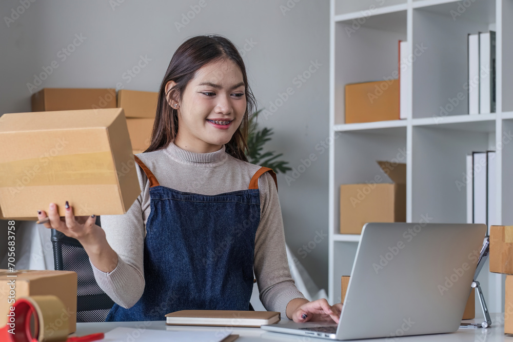 Startup small business entrepreneur SME, asian woman packing cloth in box. Portrait young Asian small business owner home office, online sell marketing delivery, SME e-commerce telemarketing concept Startup small business entrepreneur SME, asian woman packing cloth in box. Portrait young Asian small business owner home office, online sell marketing delivery, SME e-commerce telemarketing concept