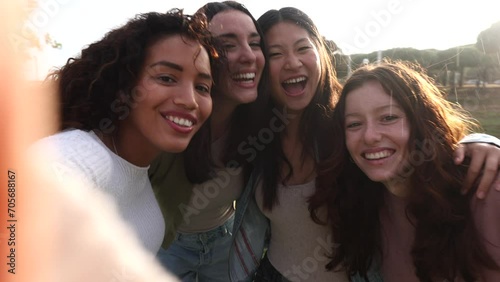 Young multiracial people taking a selfie with smar tphone and having fun in the city outdoors. photo