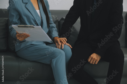 Sexsual harassment in workplace. Unhappy female employee looking at hand of boss touch at her shoulder and feeling disgusted.